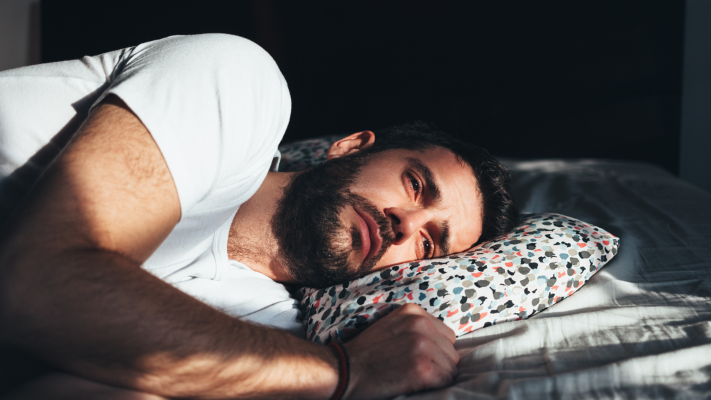 A man lies in bed.